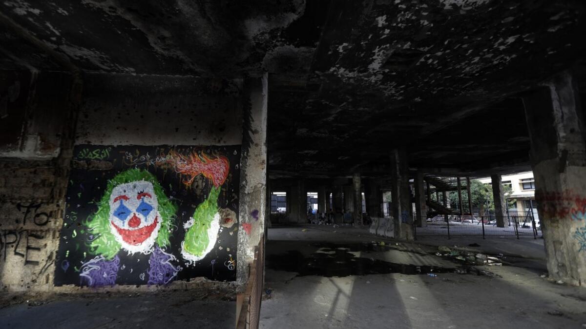 A graffiti by street artist Ashekman is sprayed inside "the Egg" building in Lebanon's capital Beirut on November 11, 2019. Since October 17, the chanting of tens of thousands of Lebanese denouncing the political elite have shaken the normally staid district around two Beirut squares, Martyrs' and Riad Al Solh. JOSEPH EID / AFP