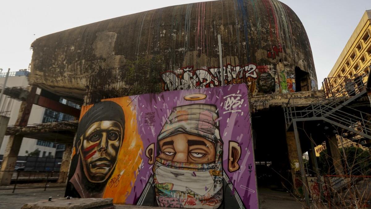 Graffitis are sprayed on a wall in front of "the Egg" building in Lebanon's capital Beirut on November 11, 2019. Since October 17, the chanting of tens of thousands of Lebanese denouncing the political elite have shaken the normally staid district around two Beirut squares, Martyrs' and Riad Al Solh. JOSEPH EID / AFP