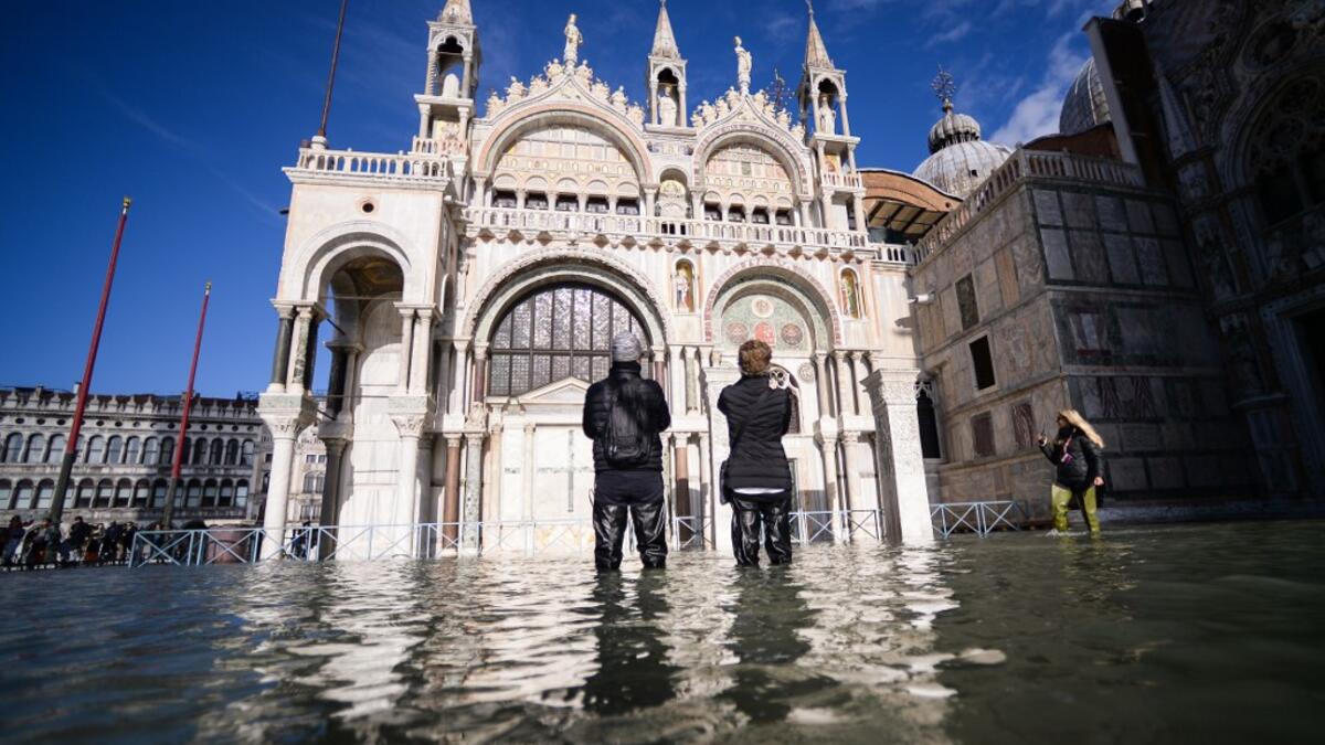 A general view shows the flooded St. Mark's Square, with St. Mark's Basilica (C) on November 14, 2019 in Venice. Much of Venice was left under water after the highest tide in 50 years ripped through the historic Italian city, beaching gondolas, trashing hotels and sending tourists fleeing through rapidly rising waters. Filippo MONTEFORTE / AFP