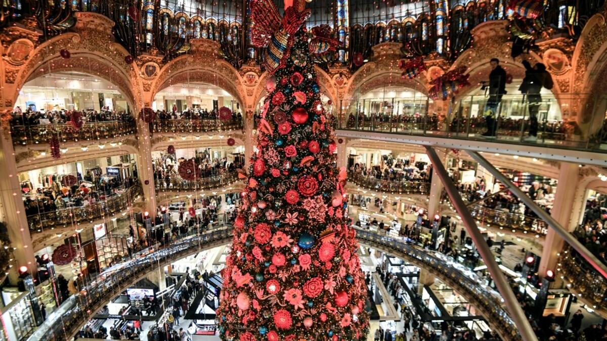 A picture taken on November 20, 2019 shows the Christmas tree during the Christmas windows opening night at the Galeries Lafayette department store in Paris ALAIN JOCARD / AFP