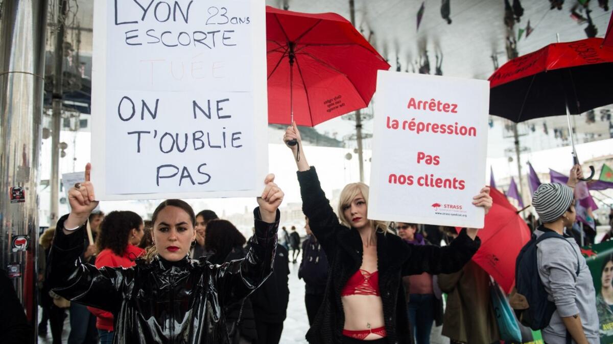 Women from the STRASS trade union (Syndicate for sexual workers) hold placards reading "Stop repression, not our clients" (R) during a protest march to condemn violence against women, on November 23, 2019 in Marseille, southern France. CLEMENT MAHOUDEAU / AFP