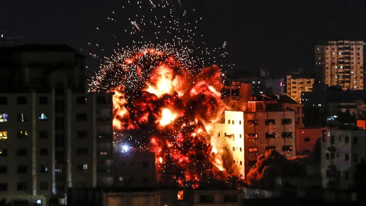 An explosion is pictured among buildings during an Israeli airstike on Gaza City on May 4, 2019. Gaza militants fired a barrage of rockets at Israel, which responded with airstrikes, officials said, as a fragile ceasefire again faltered. Mahmud Hams / AFP
