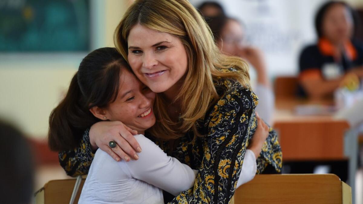 Jenna Bush Hager, daughter of former US president George W. Bush, embraces a Vietnamese student in Can Giuoc district, Long An province on December 9, 2019 during a visit with former US First Lady Michelle Obama (not pictured). Michelle Obama and Julia Roberts visit to promote girls' education in Vietnam.