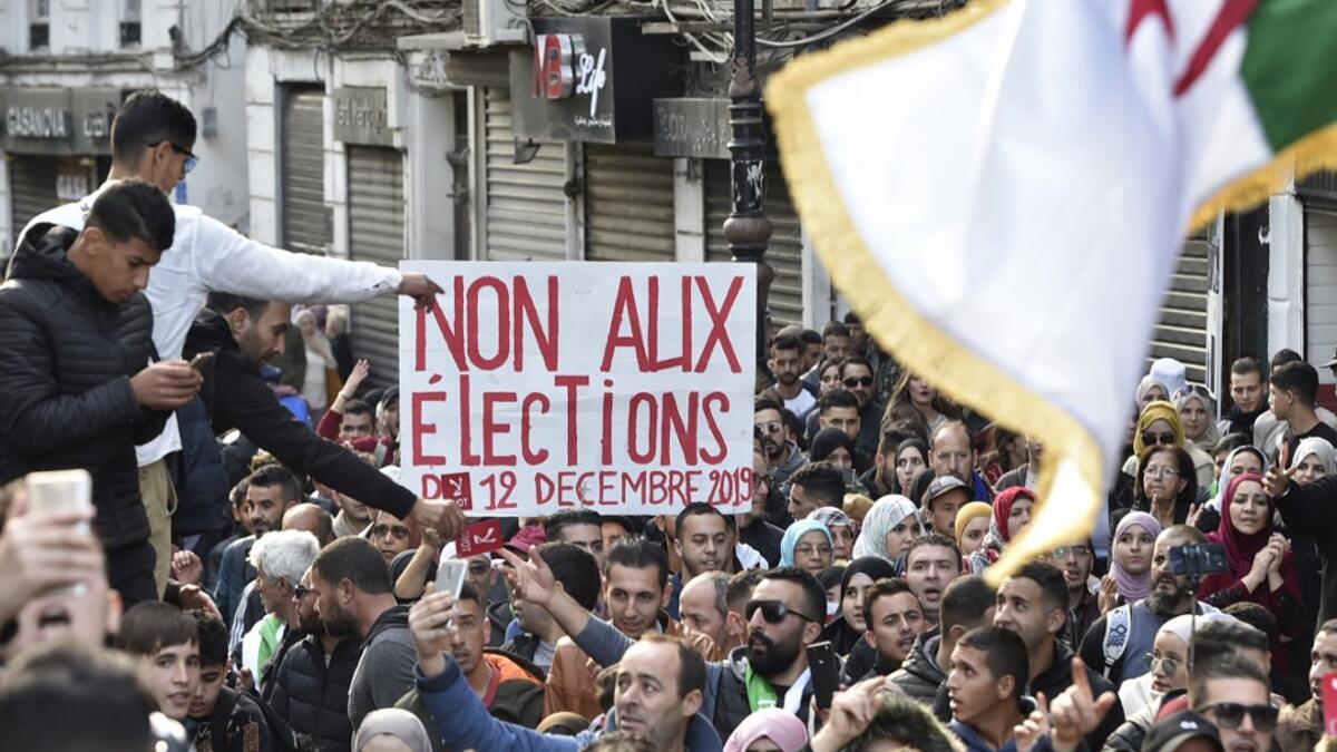 Algerian protesters shout slogans during an anti-government demonstration in the capital Algiers on December 10, 2019, ahead of the presidential vote scheduled for December 12. Algeria's contentious presidential election campaign is highlighting the vast gap between youth at the heart of a reformist protest movement and an ageing elite they see as clinging to power. RYAD KRAMDI / AFP