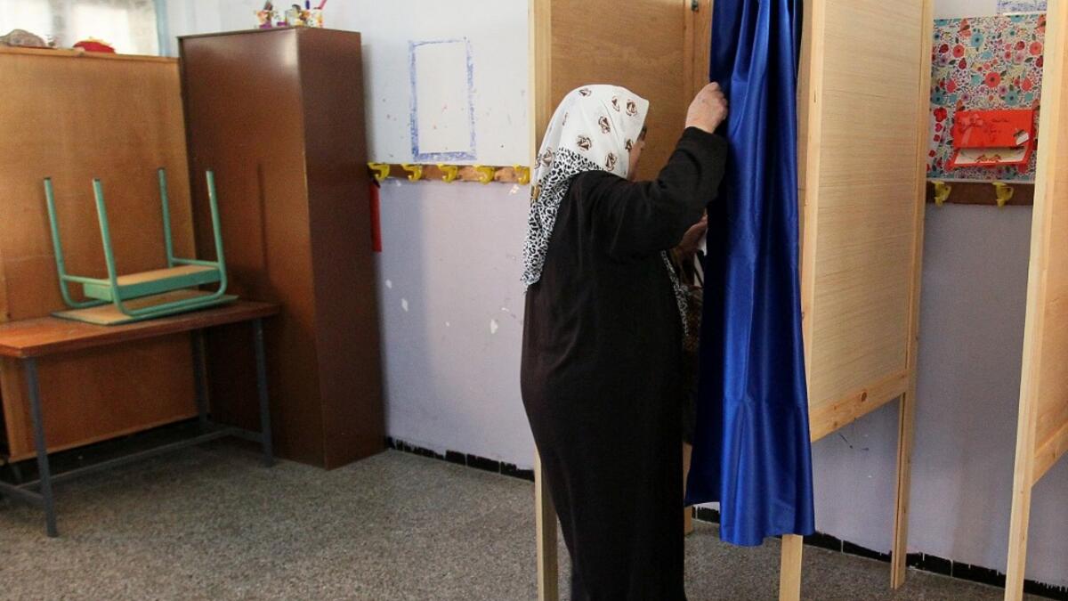 Algerians cast their votes during the presidential election on December 12, 2019 at a polling station in Algiers. Five candidates are running in Algeria's presidential election to replace ousted Algerian president Abdelaziz Bouteflika, the country's election authority said Saturday, amid widespread protests against the vote. STRINGER / AFP