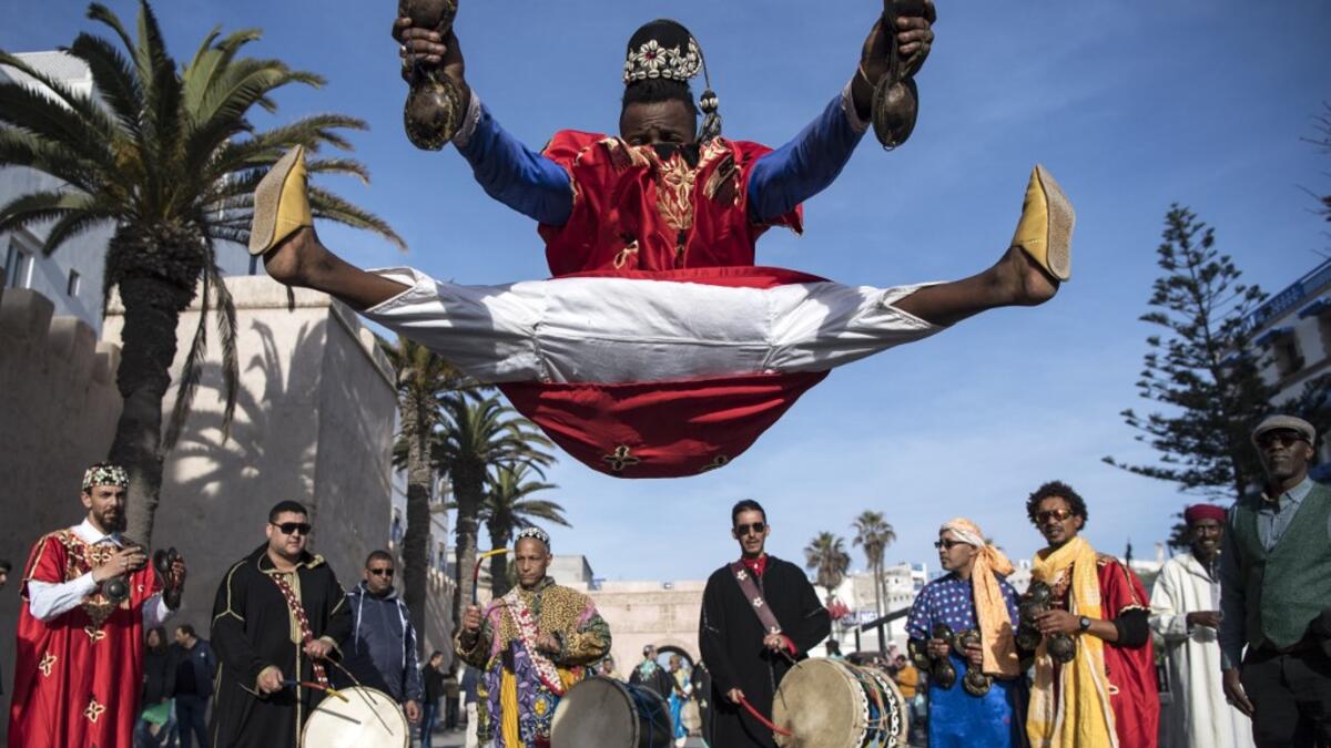 A Gnawa traditional group performs in the city of Essaouira on December 14, 2019, to celebrate the decision of adding the Gnawa culture to UNESCO's list of Intangible Cultural Heritage of Humanity. Gnawa culture, a centuries-old Moroccan practice rooted in music, African rituals and Sufi traditions, was added to UNESCO's list of Intangible Cultural Heritage of Humanity earlier in the week. FADEL SENNA / AFP