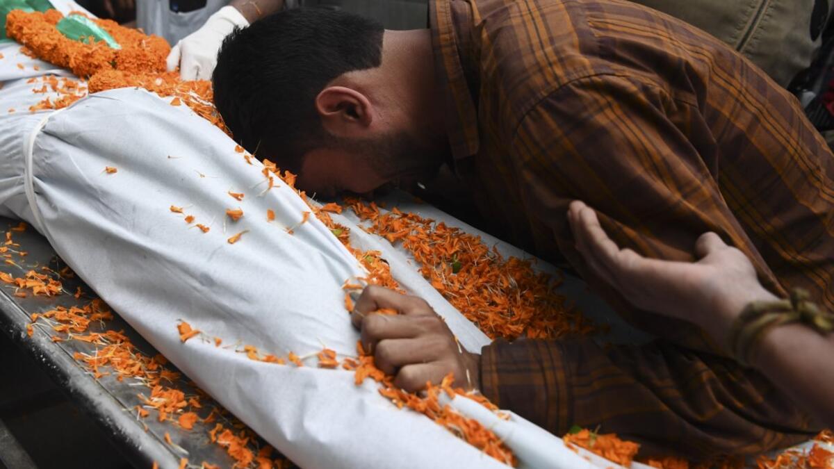 A relative mourns next to the dead body of Ishwor Nayak, 25, who was killed after police fired during a protest against the government's Citizenship Amendment Bill (CAB) three days before, in Guwahati on December 15, 2019. The death toll from violent protests in northeast India against a contentious citizenship law has risen to six, officials said on December 15, as authorities maintained internet bans and curfews to quell unrest. SAJJAD HUSSAIN / AFP