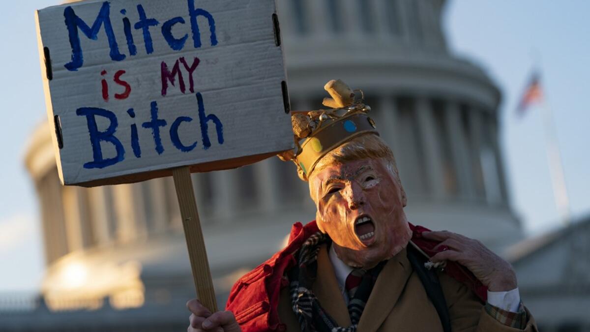 An anti Trump demonstrator protests outside the US Capitol Building in Washington, DC on December 18, 2019. The US House of Representatives is debating two articles of impeachment against US President Donald Trump. Alex Edelman / AFP