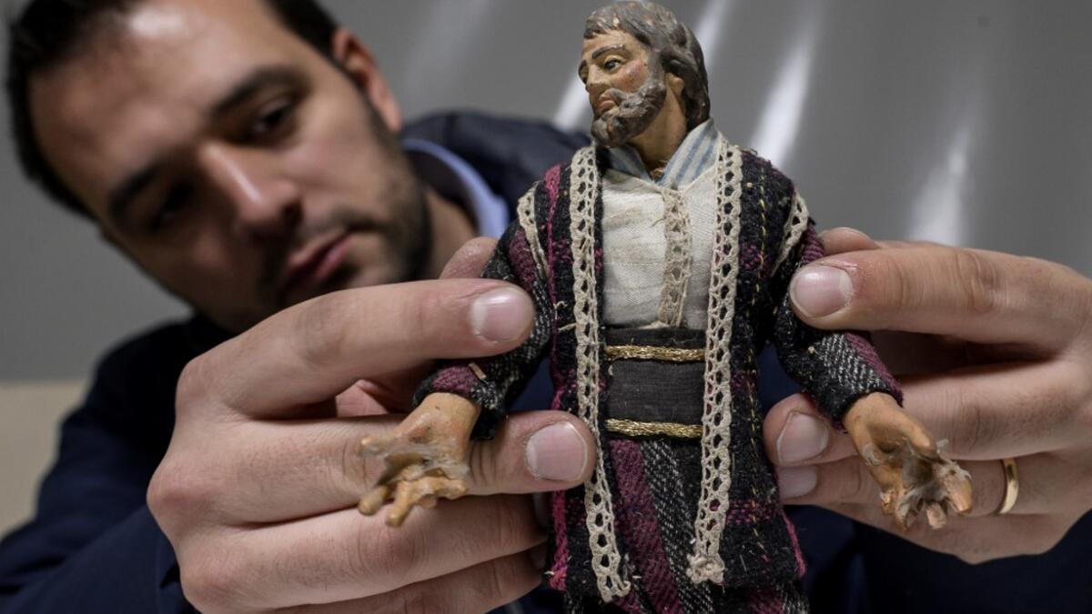 Volunteer Matteo Seia prepares a nativity figure for the 43rd edition of the "Presepio of Cavallermaggiore", a 300sqm Christmas Nativity crib in the Oratorio San Michele on December 20, 2019 in Cavallermaggiore, near Cuneo, Northwestern Italy. The "Presepio" is made by ten volunteers who every year spend 3 months to build a new edition with hundred of figures. MARCO BERTORELLO / AFP