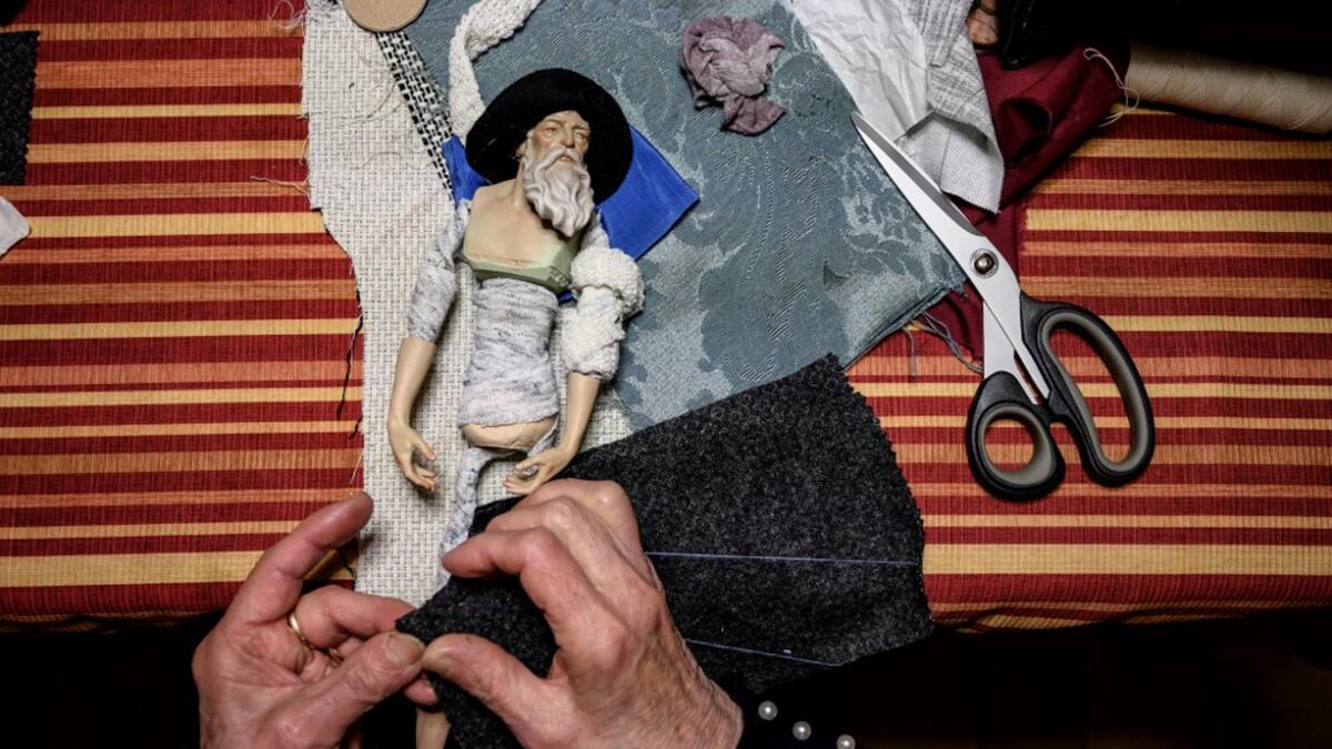 Volunteer Maria Franca Testa sews clothes for a nativity figure at the 43rd edition of the "Presepio of Cavallermaggiore", a 300sqm Christmas Nativity crib in the Oratorio San Michele on December 20, 2019 in Cavallermaggiore, near Cuneo, Northwestern Italy. The "presepio" is made by ten volunteers than every year spend 3 months to build a new edition with hundred of figures. MARCO BERTORELLO / AFP