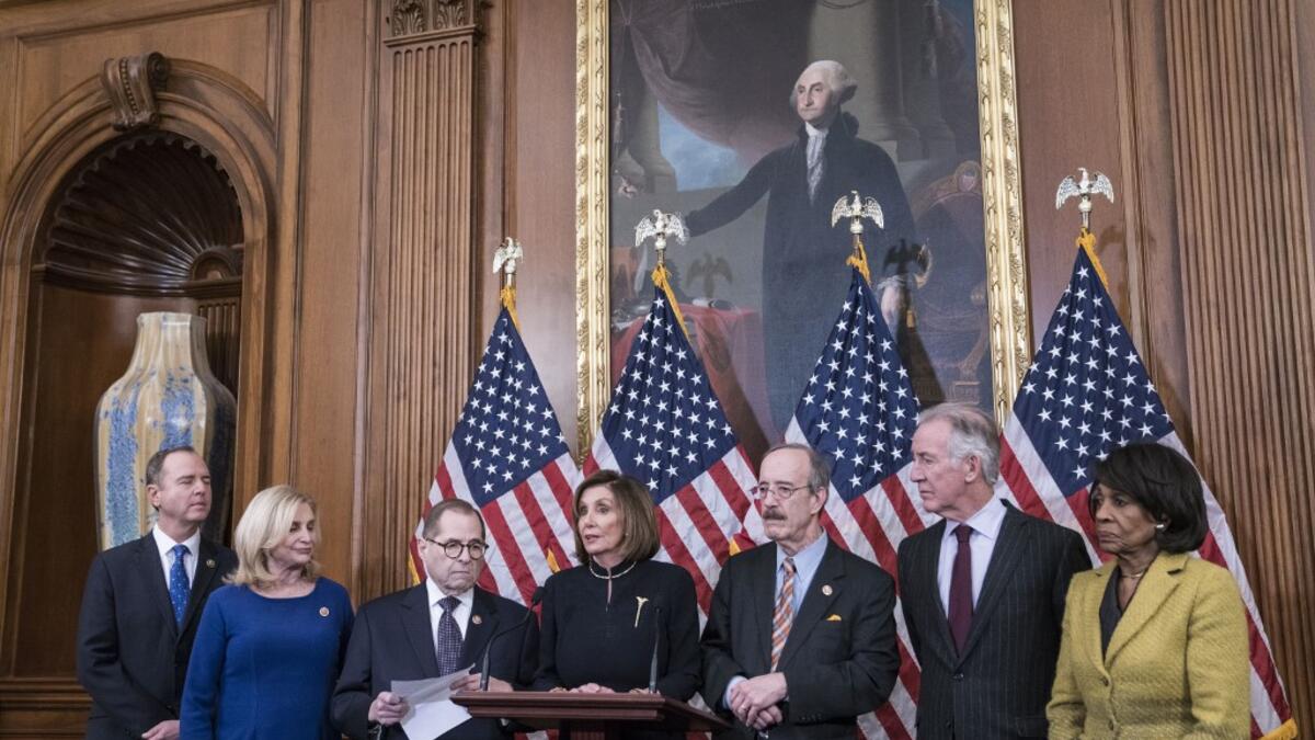 On Wednesday evening, the U.S. House of Representatives voted 230 to 197 and 229 to 198 to impeach President Trump on two articles of impeachment charging him with abuse of power and obstruction of Congress. Sarah Silbiger/Getty Images/AFP Sarah Silbiger / GETTY IMAGES NORTH AMERICA / AFP