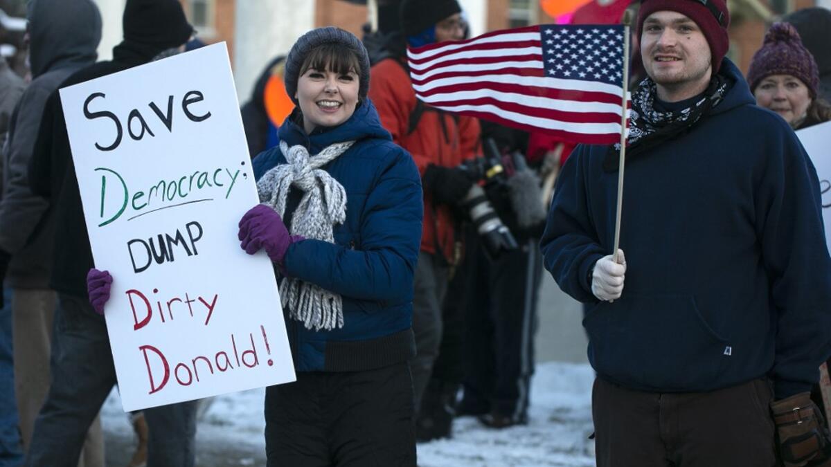 Anti-Trump protesters gather at Monument Park on December 18, 2019 in Battle Creek, Michigan. The full House of Representatives is voting on two articles of impeachment against President Donald Trump. Nuccio DiNuzzo/Getty Images/AFP