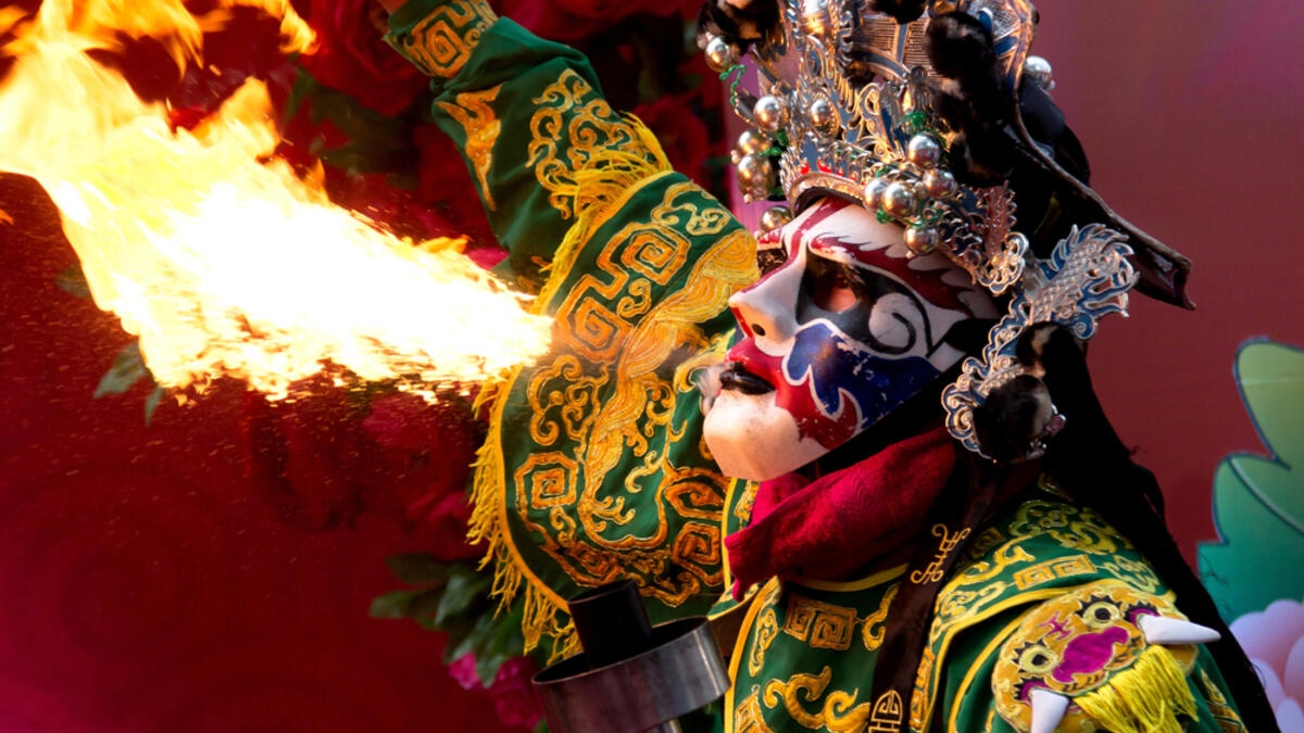 Chinese Opera actor perform spitting fire in the traditional face-changing (Shutterstock)
