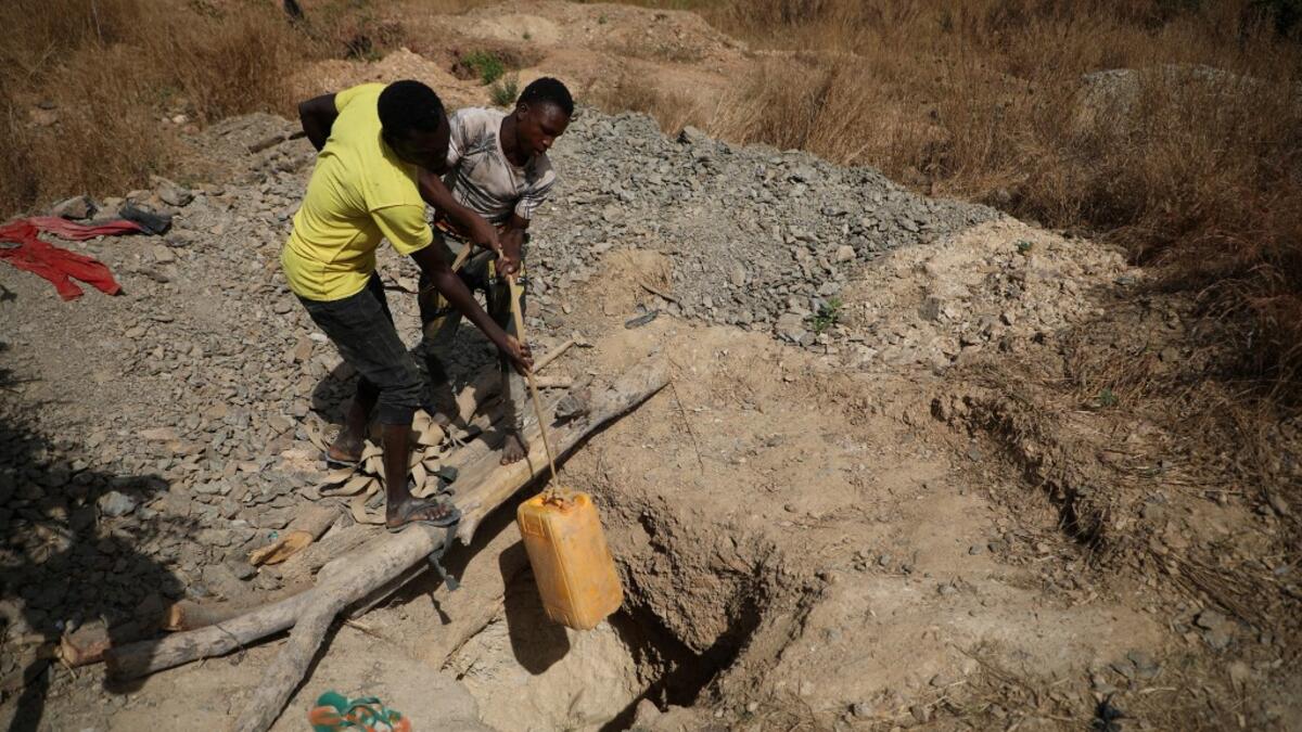 Miners work at a mining site in Anka near Gusau, on December 4,2019. For generations, the mineral-rich earth of Nigeria's Zamfara state has provided families living here with a way to make ends meet. But in recent years their trade has become increasingly unsafe. The mines lie within the reach of heavily-armed groups -- dubbed "bandits" by the local authorities -- that have been terrorising this remote region.  Kola Sulaimon / AFP