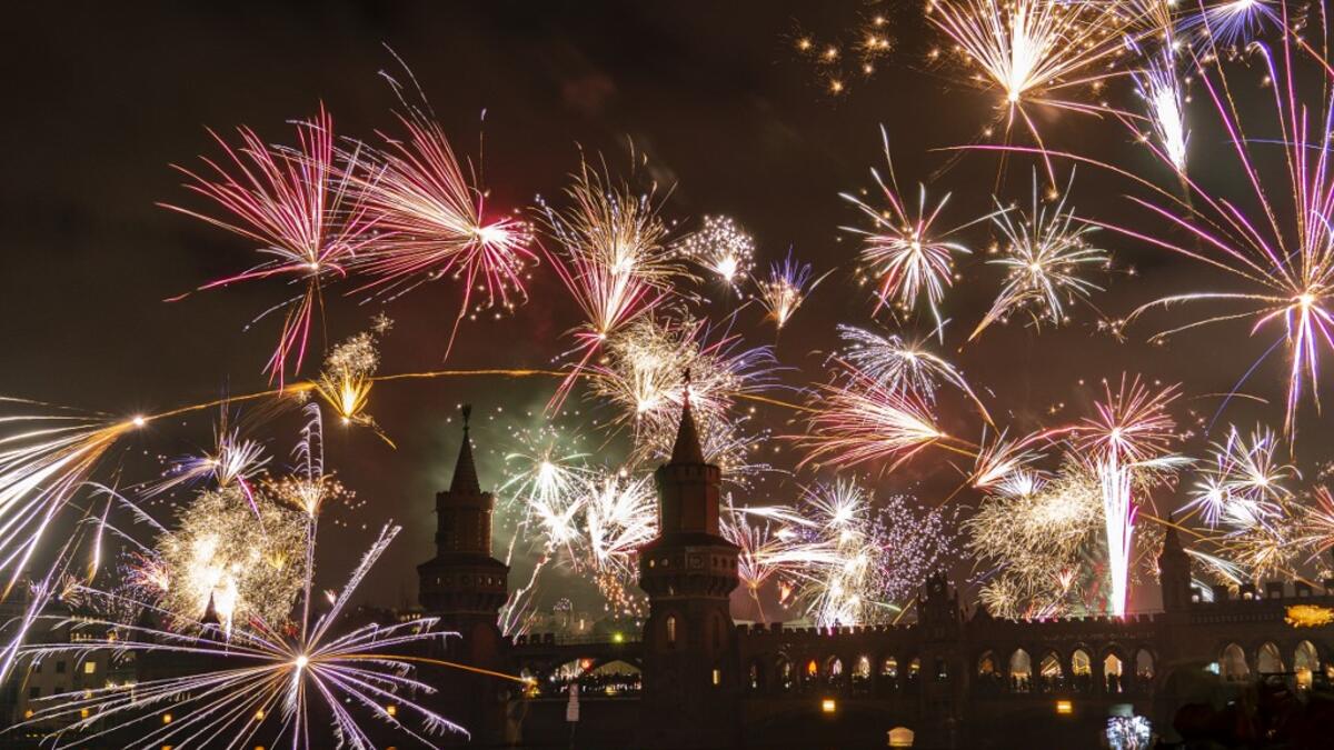 Fireworks explode over the river Spree and the Oberbaumbrücke bridge in Berlin, Germany, on January 1, 2020, to welcome the new year. Paul Zinken / dpa / AFP