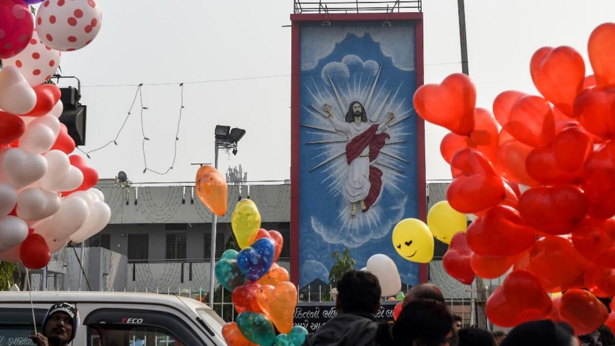 Vendors selling balloons wait for customers on the occasion of the New Year celebrations outside the Methodist Church Maninagar in Ahmedabad on January 1, 2020. SAM PANTHAKY / AFP