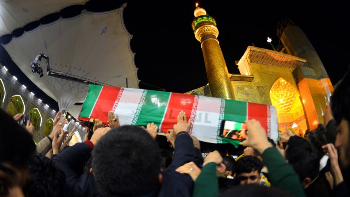 Mourners carry the coffin of slain Iranian military commander Qasem Soleimani, toward the Imam Ali Shrine, in the shrine city of Najaf in central Iraq during a funeral procession on January 4, 2020. Thousands of Iraqis chanted "Death to America" today as they mourned the deaths of al-Muhandis and Soleimani, who were killed in a US drone attack that sparked fears of a regional proxy war between Washington and Tehran. Haidar HAMDANI / AFP