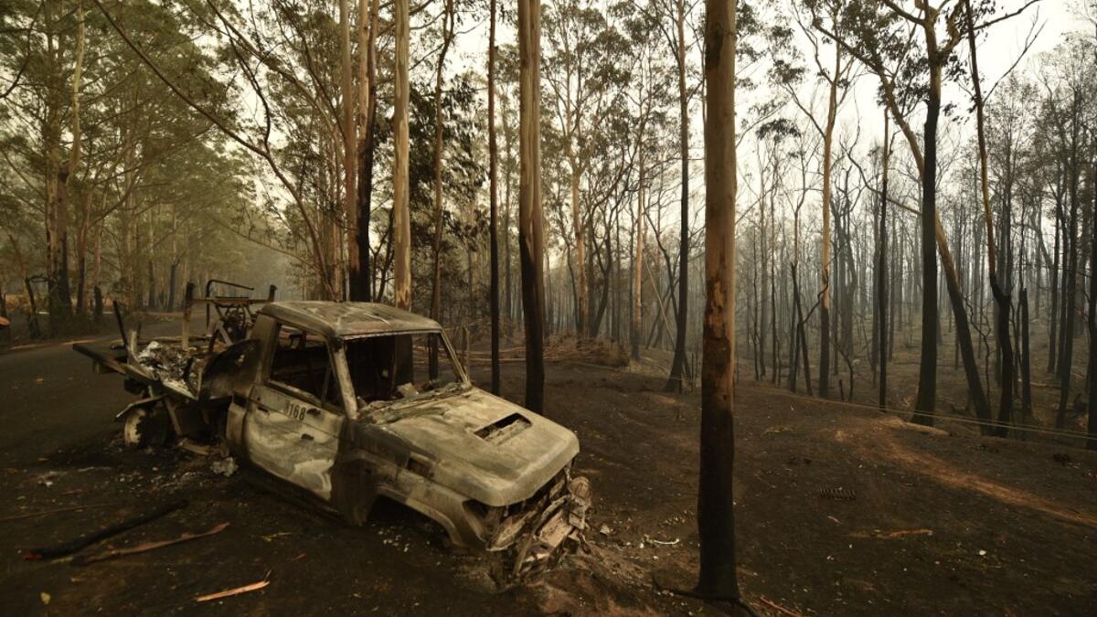 A burnt car is seen in Kangaroo Valley, in Australia's New South Wales state on January 5, 2020. Australians on January 5 counted the cost from a day of catastrophic bushfires that caused "extensive damage" across swathes of the country and took the death toll from the long-running crisis to 24. PETER PARKS / AFP