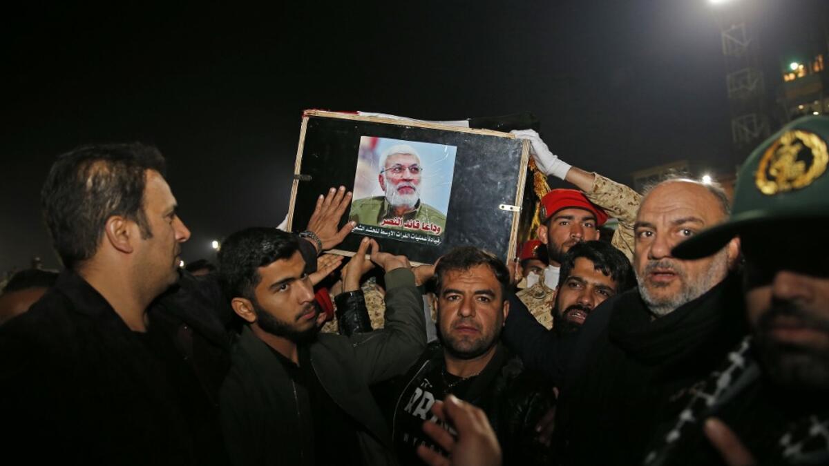 People carry the casket of Iraqi paramilitary chief Abu Mahdi al-Muhandis upon arrival at Ahvaz International Airport in southwestern Iran on January 5, 2020. A tide of mourners packed the streets of the Iranian city of Ahvaz Sunday to pay respects to top general Qasem Soleimani, days after he was killed in a US strike. HOSSEIN MERSADI / fars news / AFP