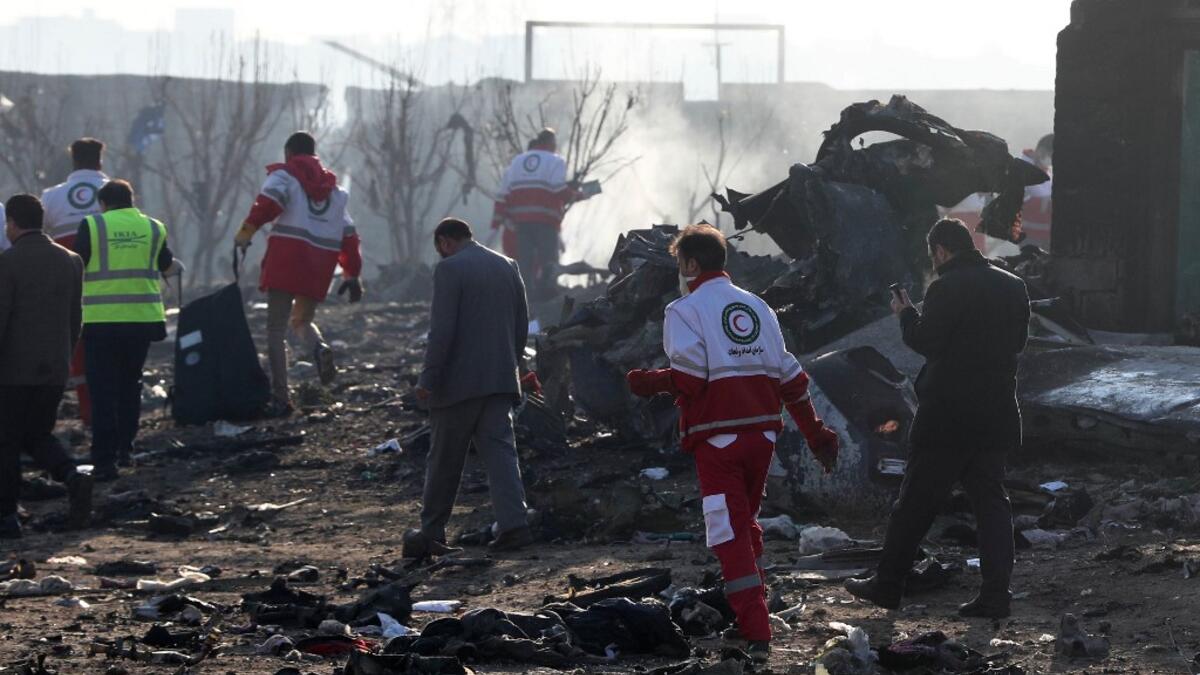 Rescue teams work amidst debris after a Ukrainian plane carrying 176 passengers crashed near Imam Khomeini airport in the Iranian capital Tehran early in the morning on January 8, 2020, killing everyone on board. The Boeing 737 had left Tehran's international airport bound for Kiev, semi-official news agency ISNA said, adding that 10 ambulances were sent to the crash site. AFP