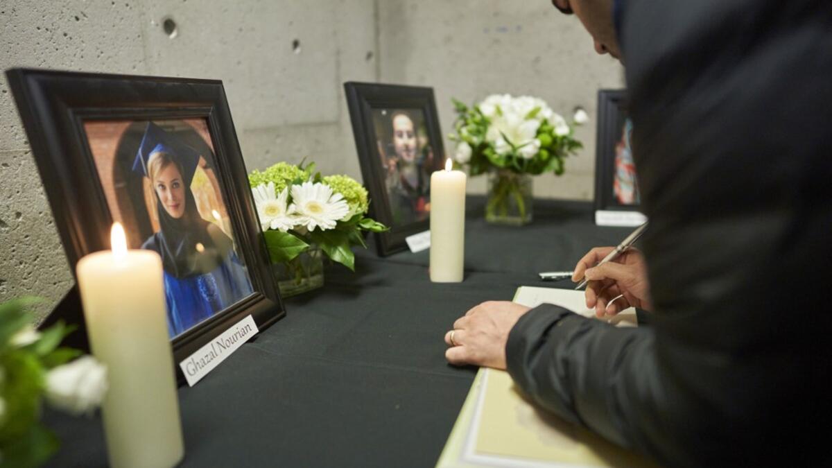 Mourners sign books of condolence at a memorial service at Western University in London, Ontario on January 8, 2020, for 4 of the school’s graduate students who were killed in the plane crash in Iran, including Ghazal Nourian. A Ukrainian airliner crashed shortly after take-off from Tehran on January 8 killing all 176 people on board, in a disaster striking a region rattled by heightened military tensions. Geoff Robins / AFP
