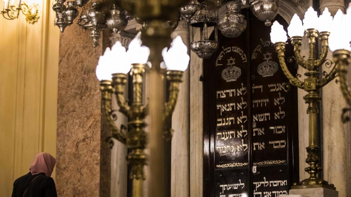 A Muslim woman visits the newly renovated Eliyahu Hanavi synagogue in the northwestern Egyptian city of Alexandria on January 10, 2020, on the day of its inauguration. The synagogue, boasting green and violet stained glass windows and towering marble columns, was built in its current form in 1850 by an Italian architect on top of the original edifice dating back to 1354. Khaled DESOUKI / AFP