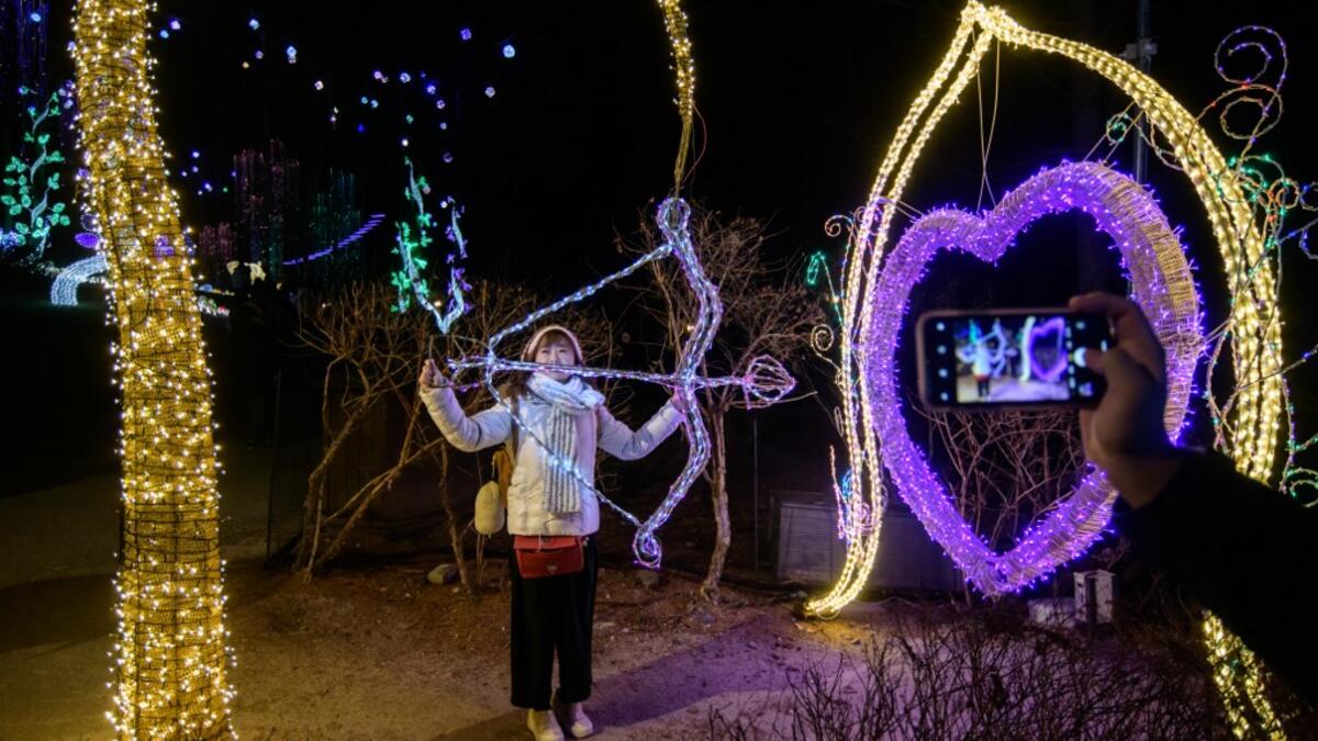 In a photo taken on January 11, 2020 visitors look at an annual light display at the 'Garden on Morning Calm', near Gapyeong, east of Seoul. Ed JONES / AFP