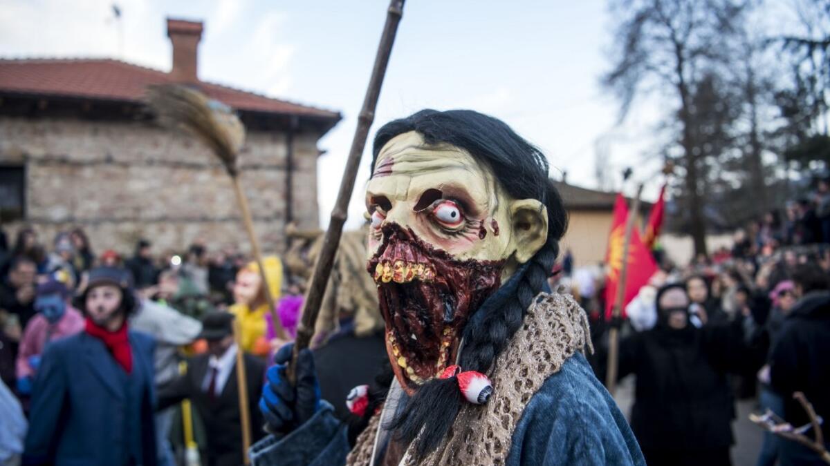 Masked revellers take part in a carnival procession through the south-western North Macedonian village of Vevcani, on January 13, 2020. The Vevcani carnival is 1.400 years old and is held every year on the eve of the feast of Saint Basil (January 14), which also marks the beginning of the New Year according to the Julian calendar, observed by the Macedonian Orthodox Church. Robert ATANASOVSKI / AFP
