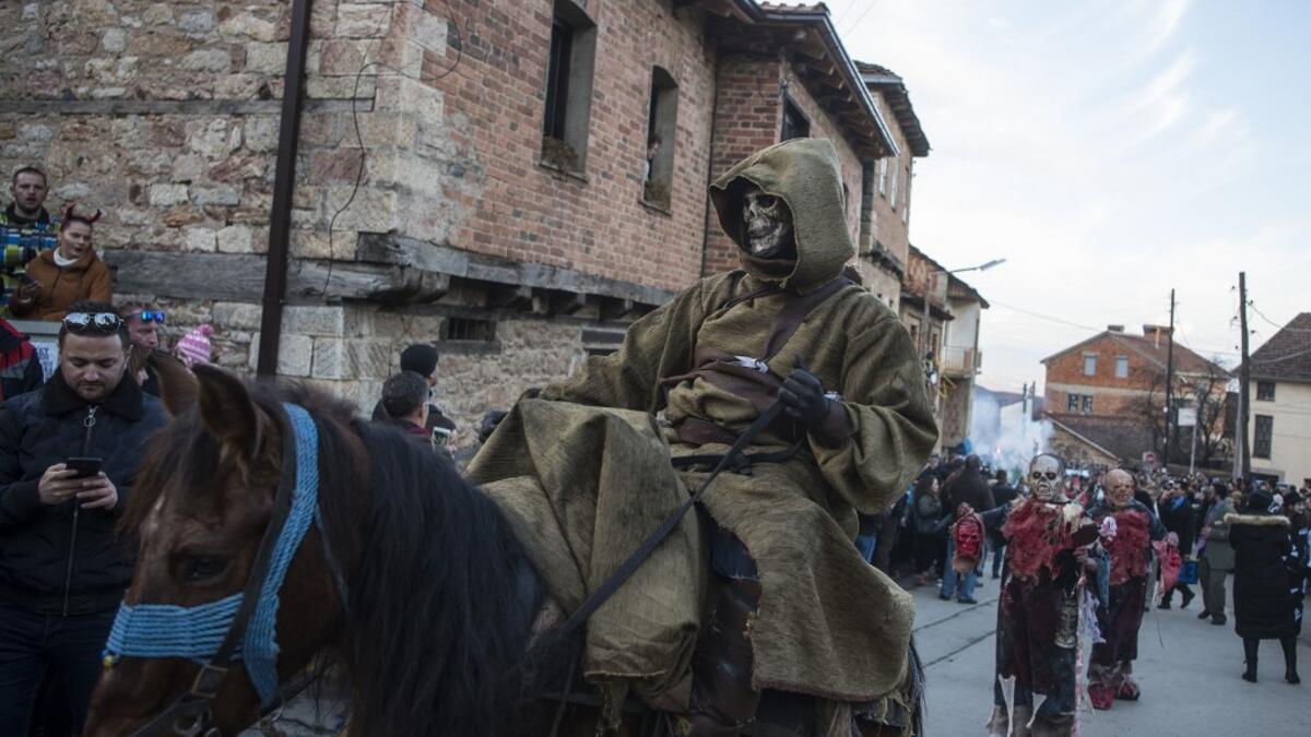 Masked revellers take part in a carnival procession through the south-western North Macedonian village of Vevcani, on January 13, 2020. The Vevcani carnival is 1.400 years old and is held every year on the eve of the feast of Saint Basil (January 14), which also marks the beginning of the New Year according to the Julian calendar, observed by the Macedonian Orthodox Church. Robert ATANASOVSKI / AFP