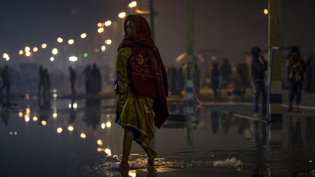 A Hindu devotee walks towards the festival area during the Gangasagar Mela, at Sagar Island, some 150 kilometres south of Kolkata on January 14, 2020. XAVIER GALIANA / AFP