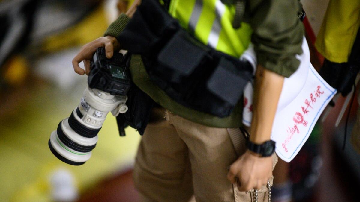 This picture taken on January 14, 2020 shows detail on a 1:6 scale action figure depicting a photographer covering the Hong Kong protests, in Hong Kong. Intricately detailed Hong Kong protester figurines have become the latest must-have collectables as toy stores recreate the pro-democracy movement's street battles with police in their shop displays.  Philip FONG / AFP