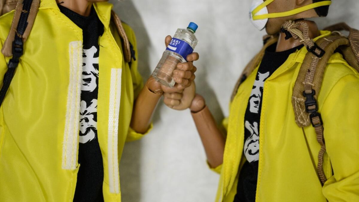 This picture taken on January 14, 2020 shows 1:6 scale action figures depicting characters involved in the Hong Kong protests, in Hong Kong. Intricately detailed Hong Kong protester figurines have become the latest must-have collectables as toy stores recreate the pro-democracy movement's street battles with police in their shop displays.  Philip FONG / AFP