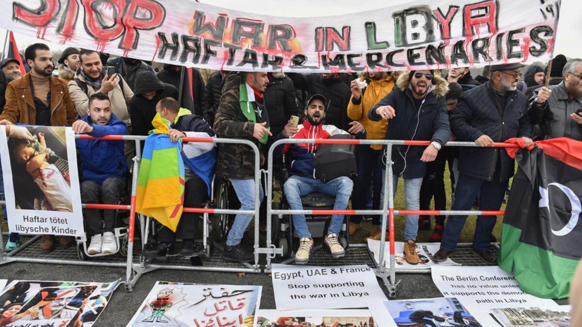 Protesters hold a banner reading "Stop war in Libya, Haftar and mercenaries" during a protest near the chancellery during the Peace summit on Libya at the Chancellery in Berlin on January 19, 2020.  AFP