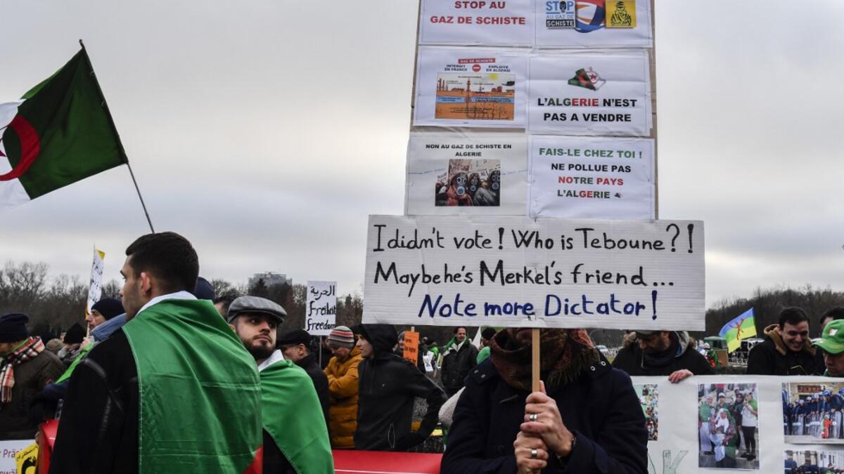 People stage a protest against Algerian president Abdelmadjid Tebboune during the Peace summit on Libya at the Chancellery in Berlin on January 19, 2020. AFP