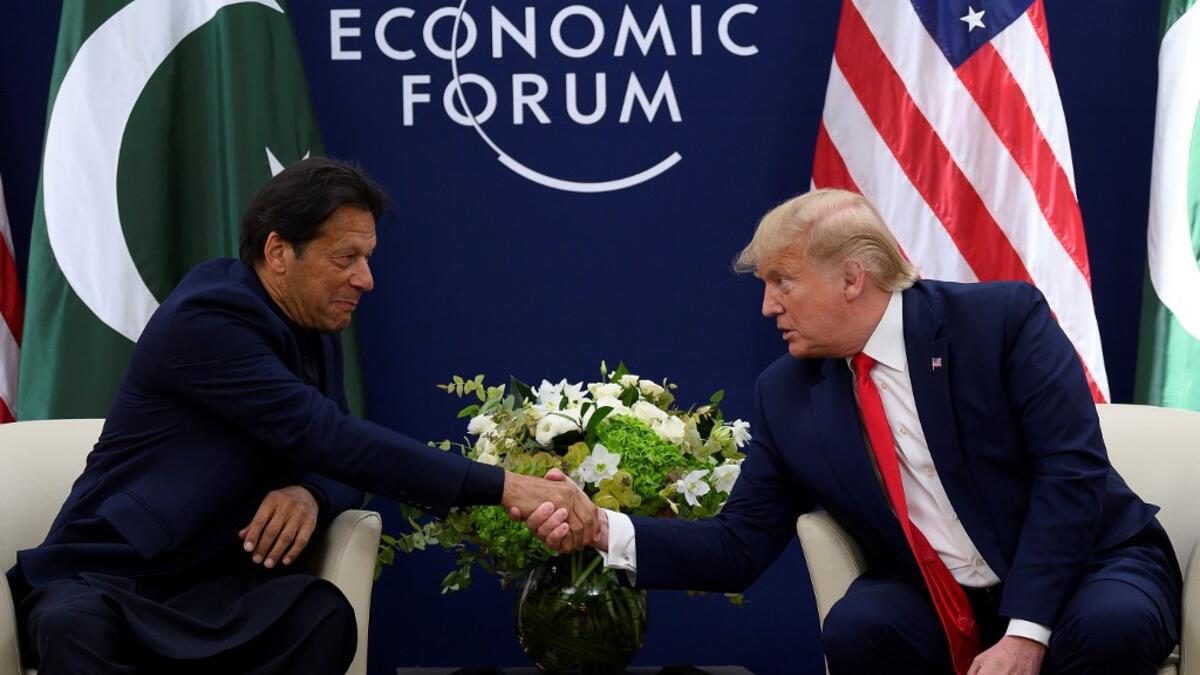US President Donald Trump (R) shakes hands with Pakistani Prime Minister Imran Khan ahead of their meeting at the World Economic Forum in Davos, on January 21, 2020. JIM WATSON / AFP