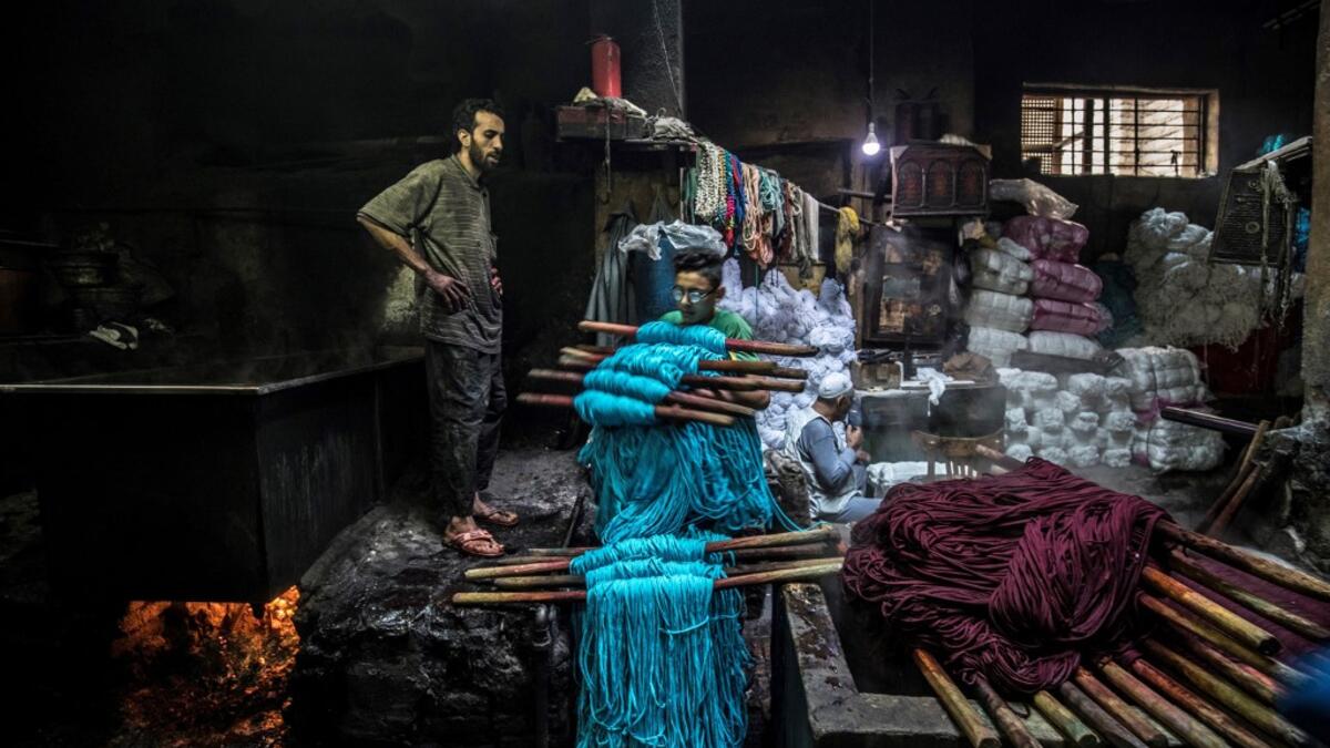 Salama and his relatives lay out the long, flowing threads, which will be used for everything from handmade shoes to rugs and drapes, and dip them in huge, piping-hot colour baths -- no gloves or masks protecting them from the dyes and chemical fumes. The workshop in Islamic Cairo has been going strong for over a hundred years. Khaled DESOUKI / AFP