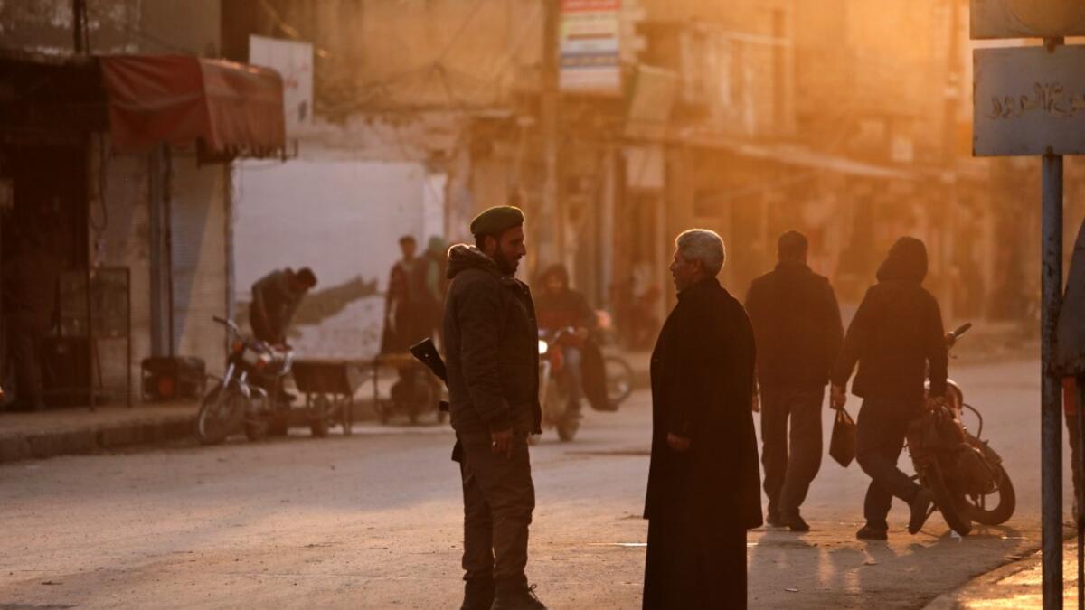 A man speaks with a Turkish-backed Syrian fighter in the northern Syrian town of Tal Abyad by the border with Turkey on February 4, 2020. Bakr ALKASEM / AFP