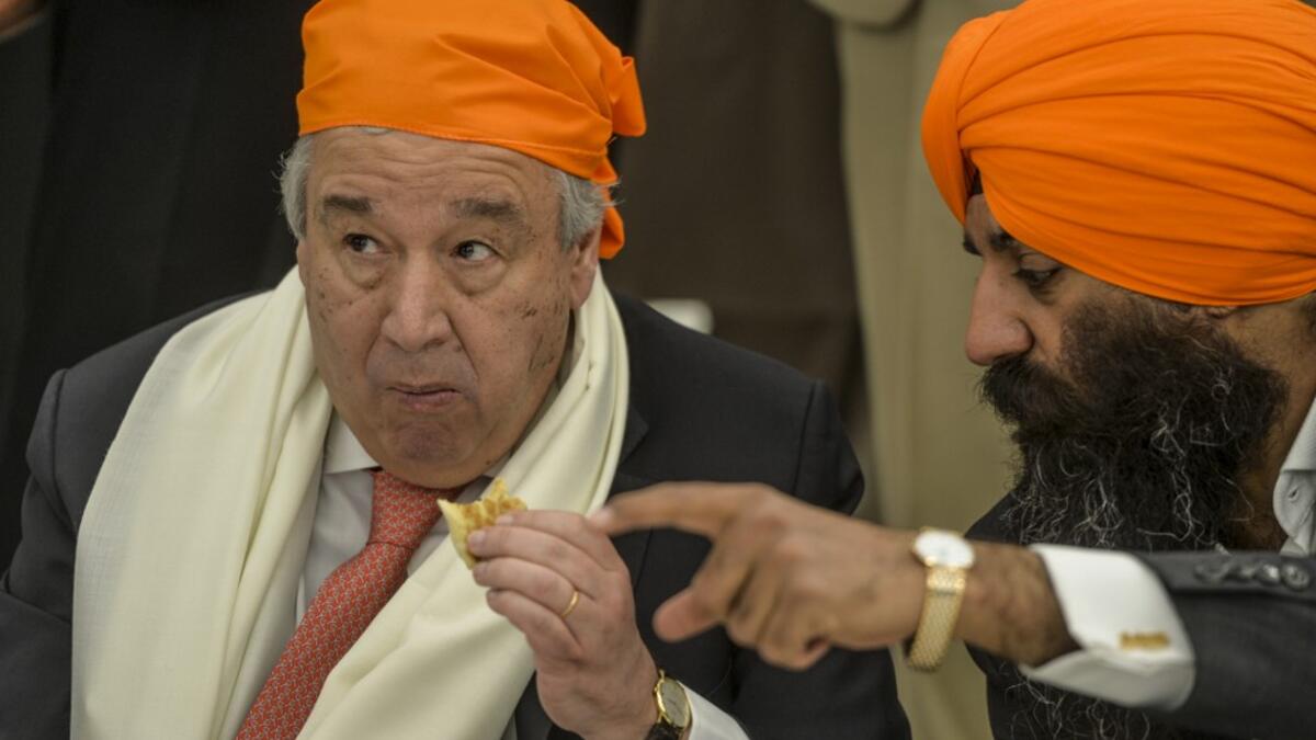 United Nations Secretary-General Antonio Guterres (L) eats food as he listens to politician and custodian of the Kartarpur shrine Ramesh Singh Arora (R) at the Langar Khana during his visit of the Sikh Shrine of Baba Guru Nanak Dev at Gurdwara Darbar Sahib in Kartarpur near the Pakistan-India border, on February 18, 2020. Aamir QURESHI / AFP