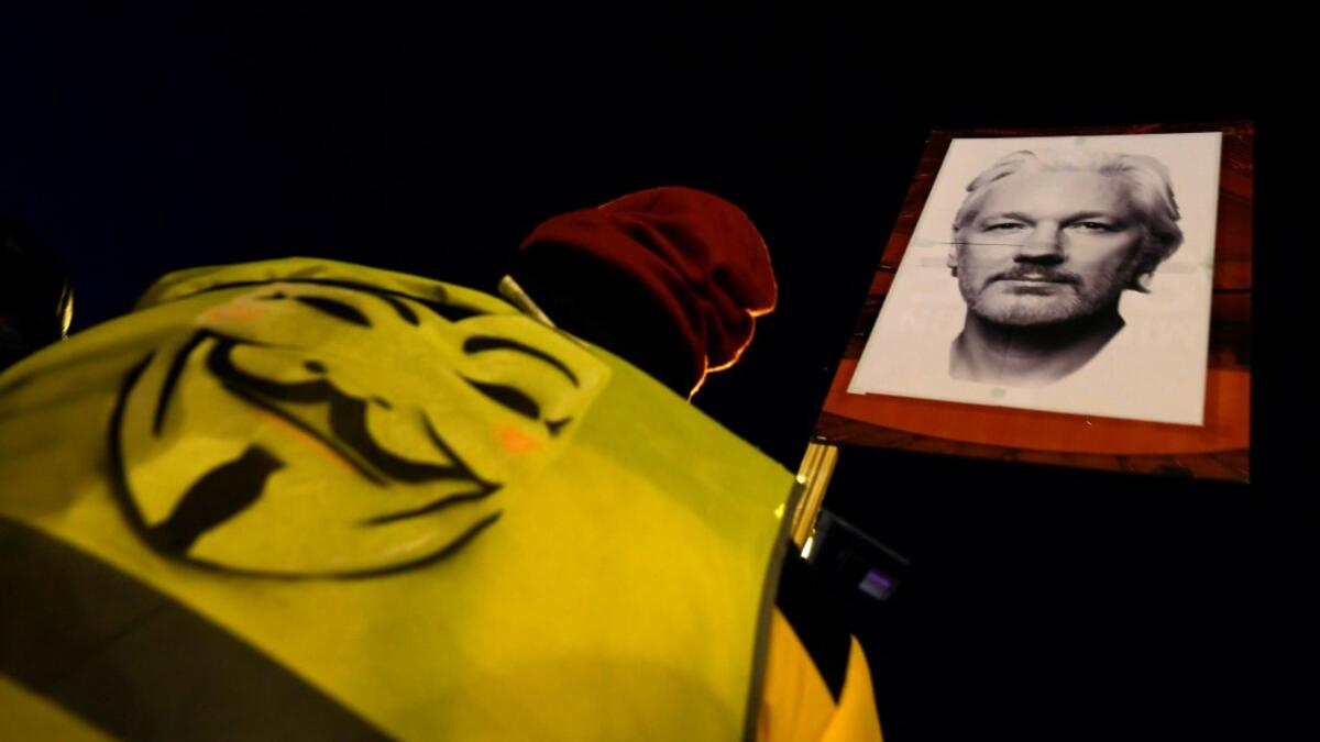A demonstrator holds a picture of WikiLeaks founder Julian Assange during a supporting protest called by Catalan National Assembly (ANC) under the motto "Journalism is not a crime" in Barcelona on February 24, 2020. A British court today started hearing Washington's extradition request for WikiLeaks founder Julian Assange in a test case of media freedoms in the digital age and the global limits of US justice. LLUIS GENE / AFP