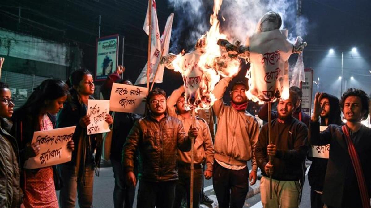 Protesters set fire to effigies of the prime minister and vandalised two BJP offices [Biju Boro/ AFP]