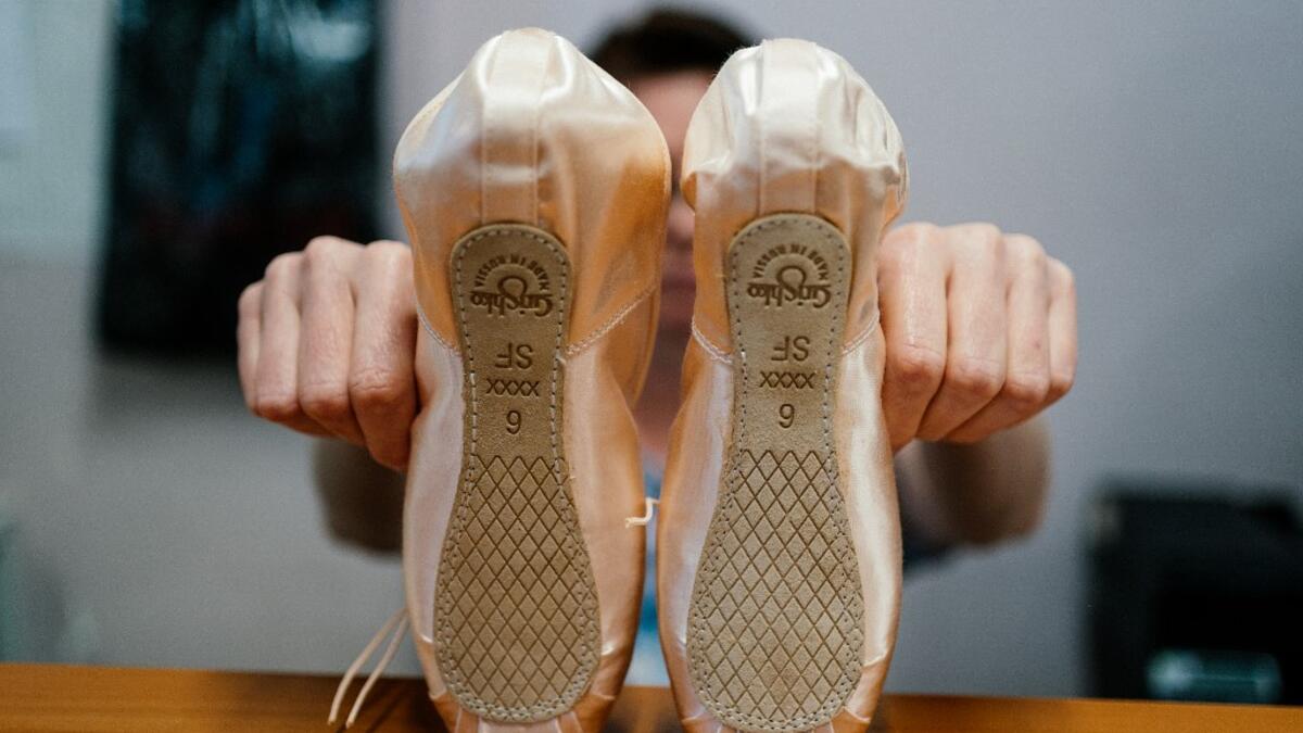 An employee of Grishko company produces pointe shoes in the company's Moscow workshop on February 25, 2020. Born in the chaos of the collapse of the Soviet Union, the Grishko family business has emerged among the top makers in the world of dance shoes, notably classic ballet pointe shoes, worn on the world's great stages. Dimitar DILKOFF / AFP