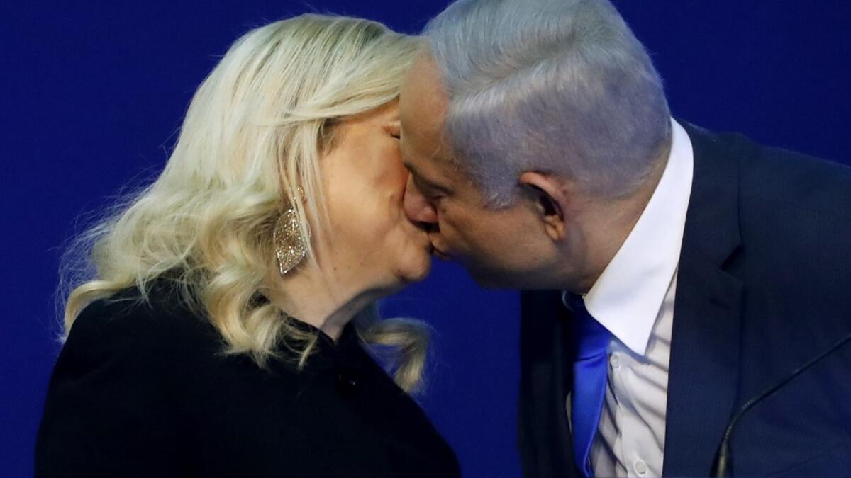 Israeli Prime Minister Benjamin Netanyahu kisses his wife Sara before addressing supporters at the Likud party campaign headquarters in the coastal city of Tel Aviv early on March 3, 2020, after polls officially closed. Netanyahu claimed "a giant victory" in elections on March 3, boasting that his right-wing Likud party had defied "all expectations" in the country's third vote in less than a year. After exit polls by three networks forecast that Likud and its allies were on track to win 59 parliamentary sea