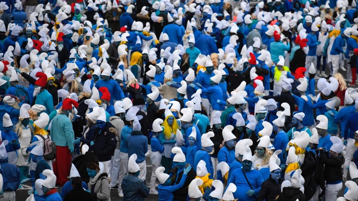 People dressed as Smurfs ('Schtroumpfs' in French), a Belgian comic franchise centered on a fictional colony of small, blue, human-like creatures who live in mushroom-shaped houses in the forest, attend a world record gathering of Smurfs on March 7, 2020, in Landerneau, western France. Damien MEYER / AFP