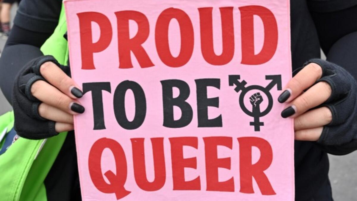 An Indonesian woman holds a banner to mark the International Women’s Day in Jakarta on March 8, 2020. ADEK BERRY / AFP