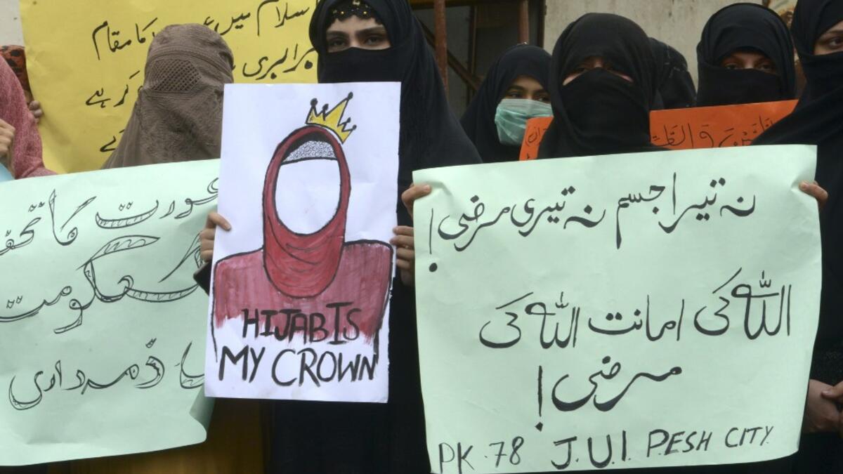 Burqa-clad female activists of Islamic political party Jamiat Ulema-e-Islam (JUI-F), carry placards during a rally to mark the International Women's Day in Peshawar on March 8, 2020. Thousands of people are expected to rally in cities across Pakistan on March 8 to mark International Women's Day in an ultra-conservative society where women are still put to death under ancient "honour" codes. Abdul MAJEED / AFP