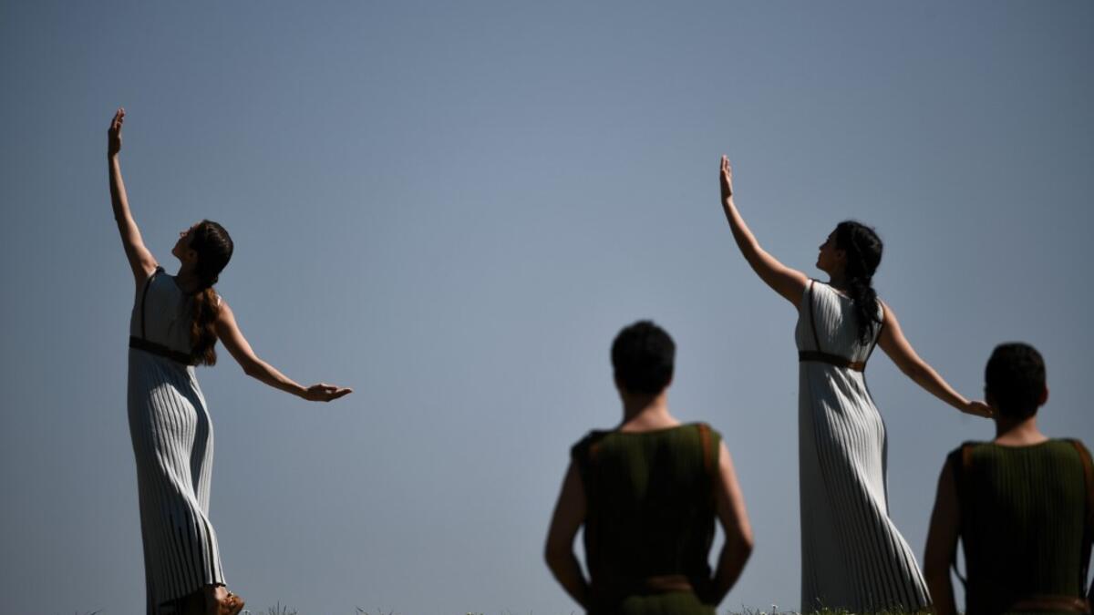 Participants dressed in ancient attire take part in the Olympic flame lighting ceremony in ancient Olympia, on March 12, 2020 ahead of Tokyo 2020 Olympic Games. ARIS MESSINIS / AFP