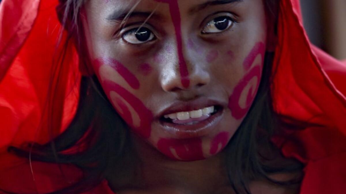 A Wayuu girl poses for a picture before performing the traditional La Yonna dance, in Tres Bocas, northern Colombia, on March 13, 2020. Juan BARRETO / AFP