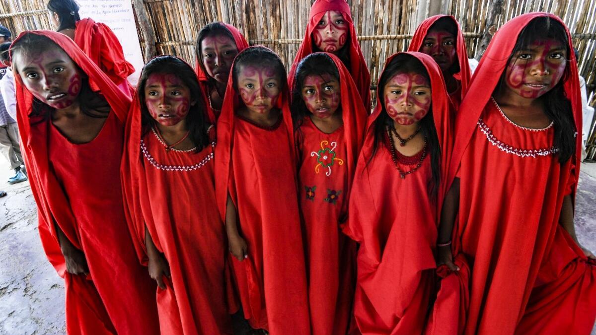 Wayuu girls prepare to perform the traditional La Yonna dance, in Tres Bocas, northern Colombia, on March 13, 2020. Juan BARRETO / AFP