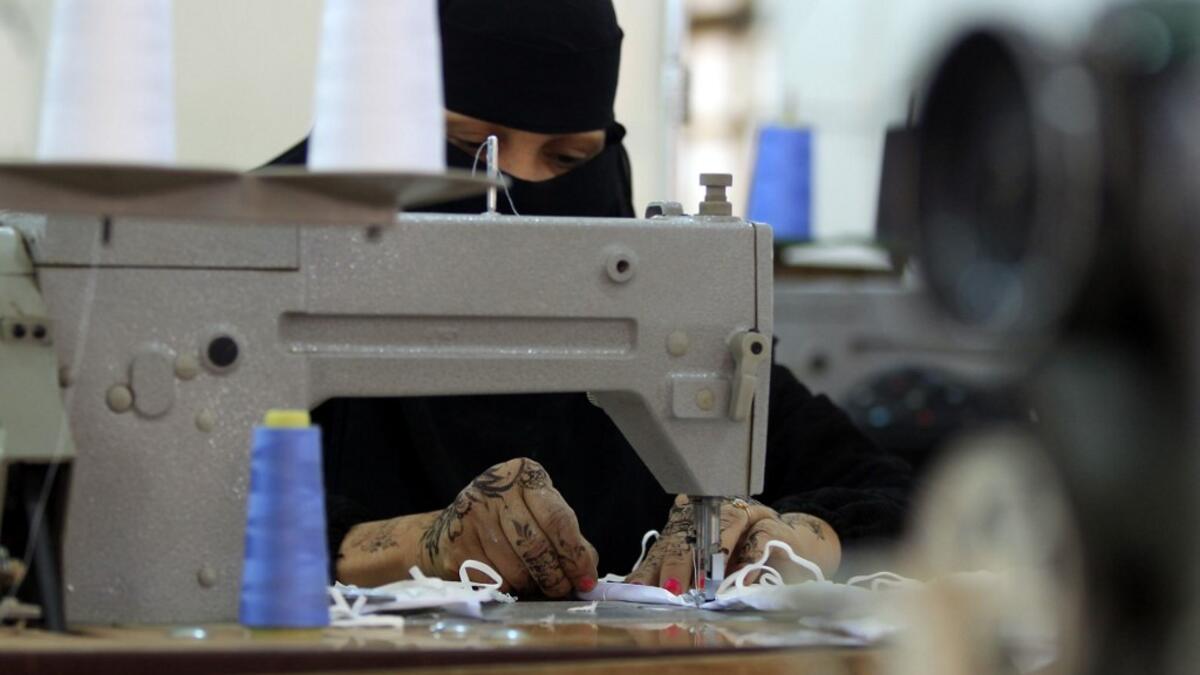 Yemeni women make face masks at the textile factory in the capital Sanaa on March 16, 2020. Yemen's Huthi rebels said they would suspend passenger flights in and out of Sanaa airport for two weeks to prevent the introduction of novel coronavirus. The country has not to date announced any cases of the COVID-19 illness, but the poor state of the country's health infrastructure after five years of war would mean that such an outbreak could be catastrophic.  MOHAMMED HUWAIS / AFP