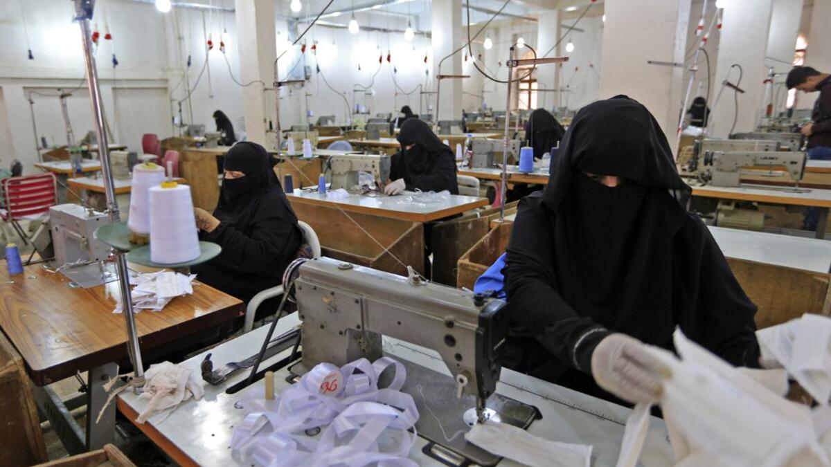 Yemeni women make face masks at a textile factory in the capital Sanaa on March 16, 2020. More than a decade after it shut down, 20 women have brought back to life Yemen's oldest industrial factory to manufacture what could save many lives amid a global pandemic: masks. Mohammed HUWAIS / AFP
